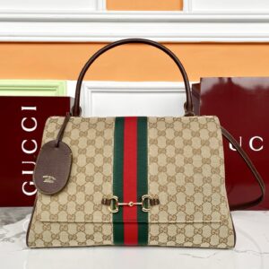 This bag is crafted from the signature GG canvas. Sand and dark brown GG canvas Brown leather trim Gold-tone hardware Sand-colored canvas lining with a diamond pattern Detachable and adjustable leather shoulder strap Dimensions: 37 x 29 x 13 cm