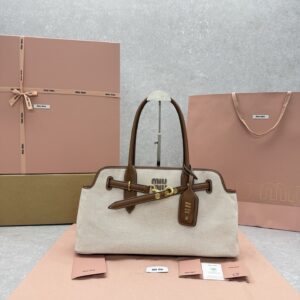 {Canvas & Brown} Miu Miu Aventure Bag: Classic beige-apricot canvas paired with warm-toned calfskin. Dimensions: 45 x 15 x 35 cm.