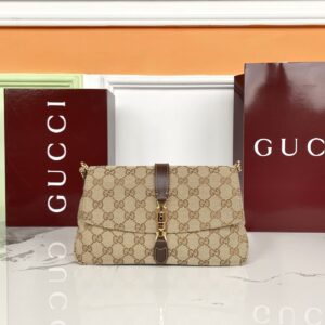 Crafted from sand-colored and dark brown GG canvas Dark brown soft leather trim Gold-tone hardware Sand-colored canvas lining with a diamond-pattern motif Detachable and adjustable leather shoulder strap Dimensions: 26 x 14.5 x 3.5 cm